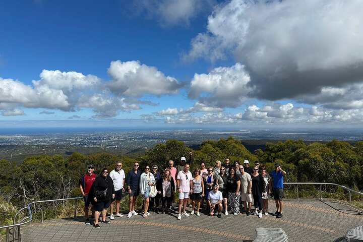 a group of people standing in front of a cloudy sky